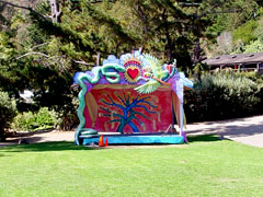 Funky theater stage on large grassy lawn.
