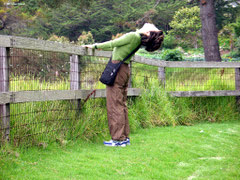 Woman stretches her back.